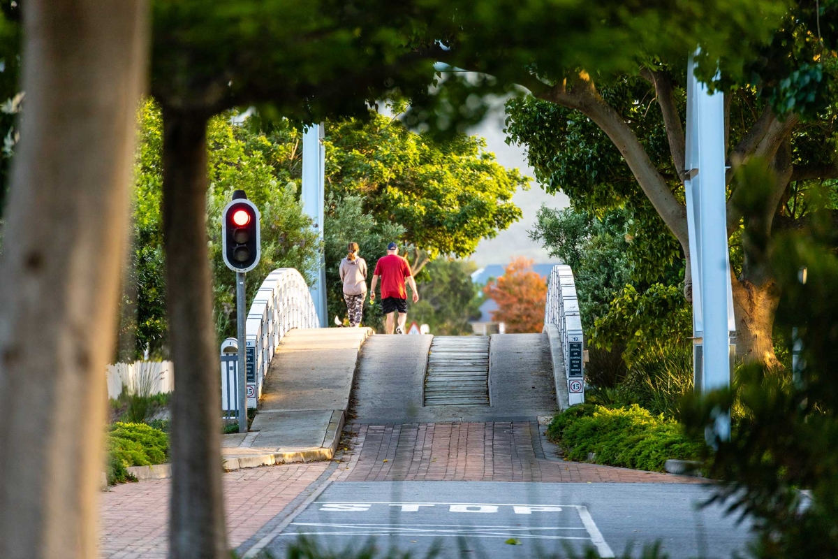 Couple walking over one of the island's arched bridges