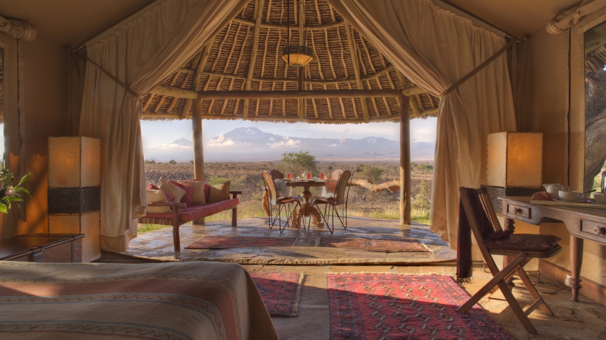 Interior of a elegant tented suite looking out onto the vast wilderness views