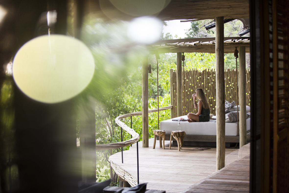 Women enjoying the serenity of her private veranda and day bed