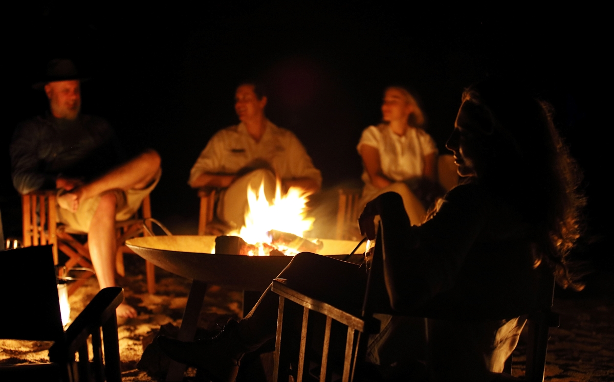 guests talking around a bonfire