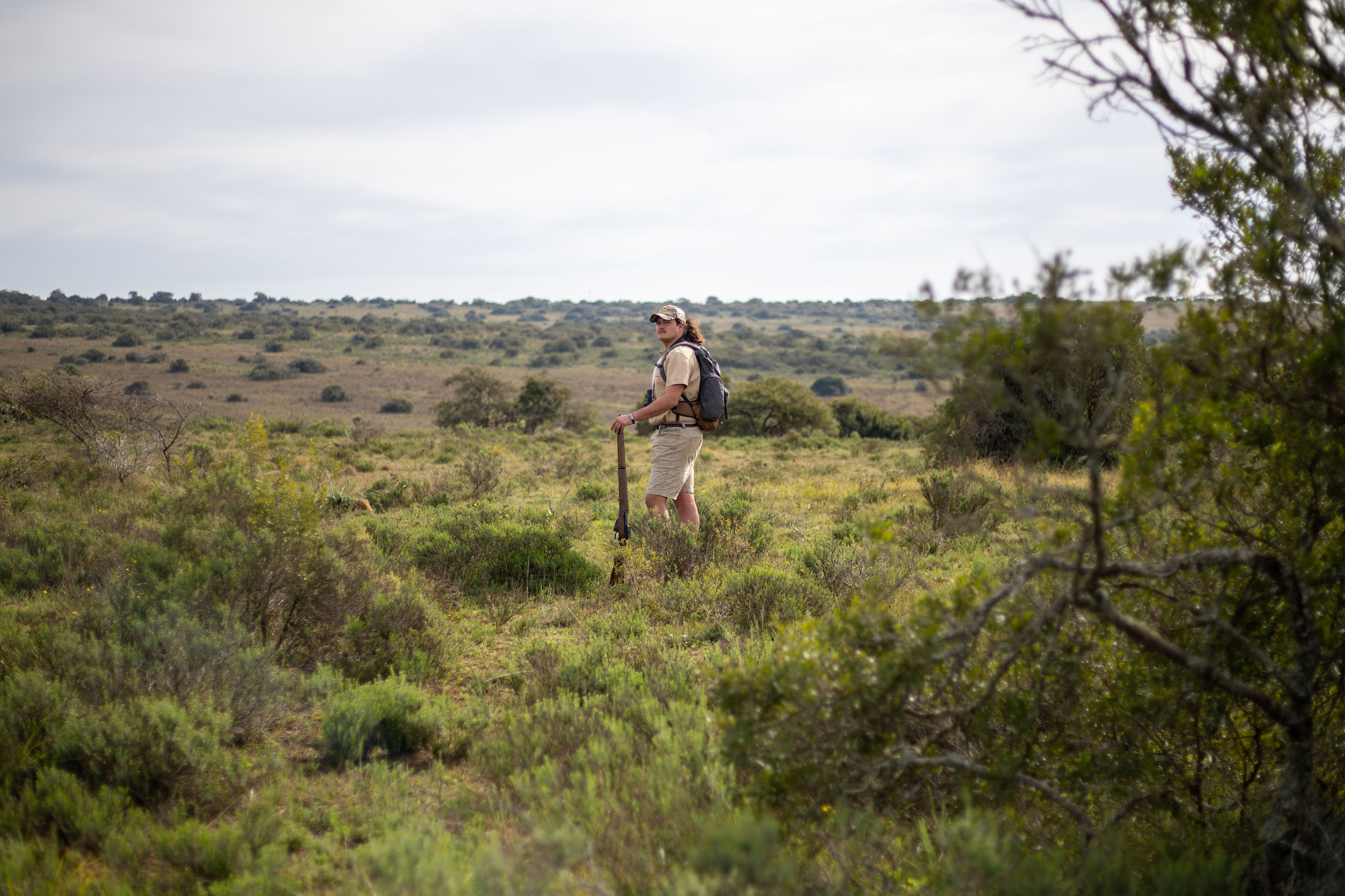 Guide on a bush walk at Hlosi Lodge in Amakhala Private Game Reserve