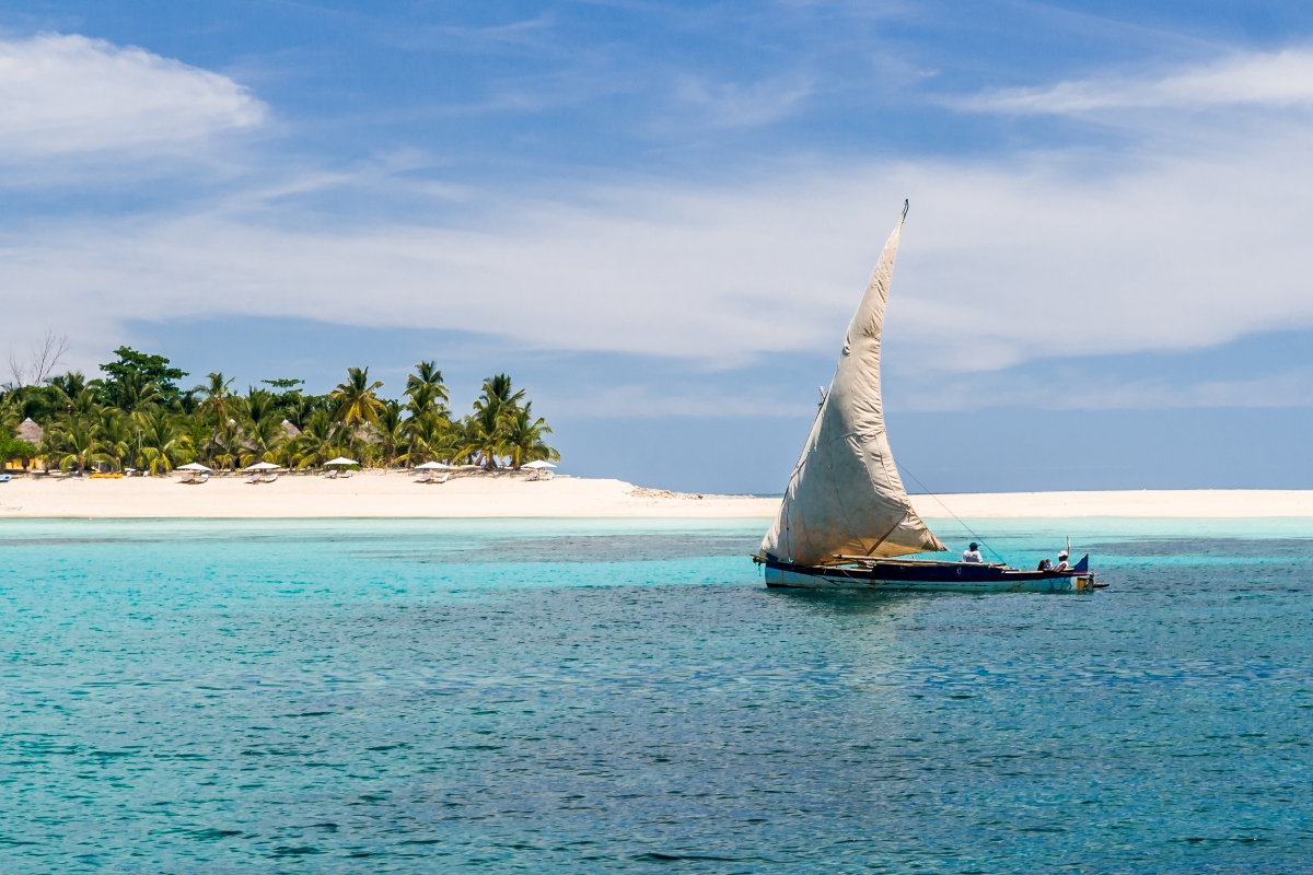 Small fishing sailing ship along a picturesque coastline