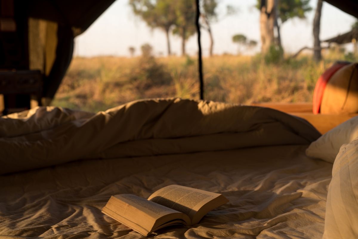 Book on bed in luxury tent 