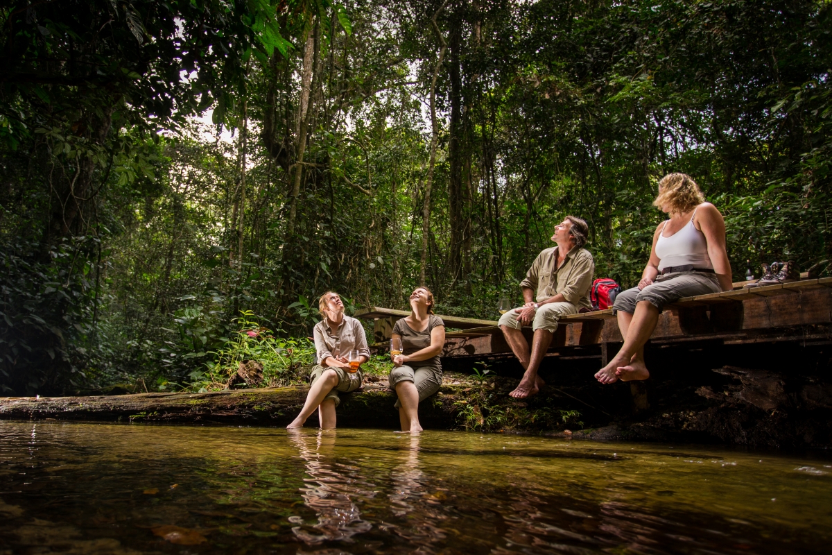 Guests sitting at the river's edge appreciating the surroundings