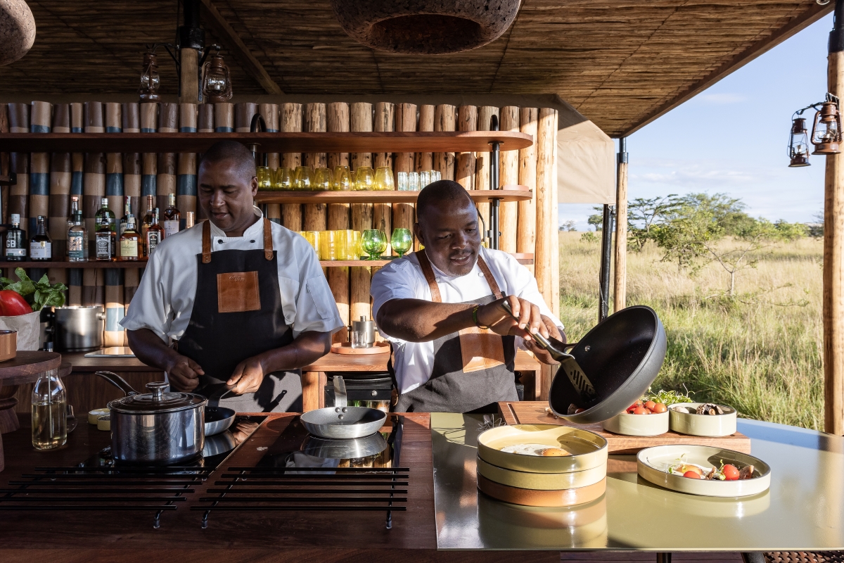 Two staff members preparing food and drinks