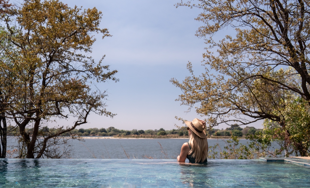 Woman in infinity pool overlooking the Zambezi River