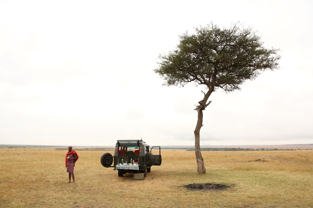 Maasai guide preparing a bush breakfast on the plains