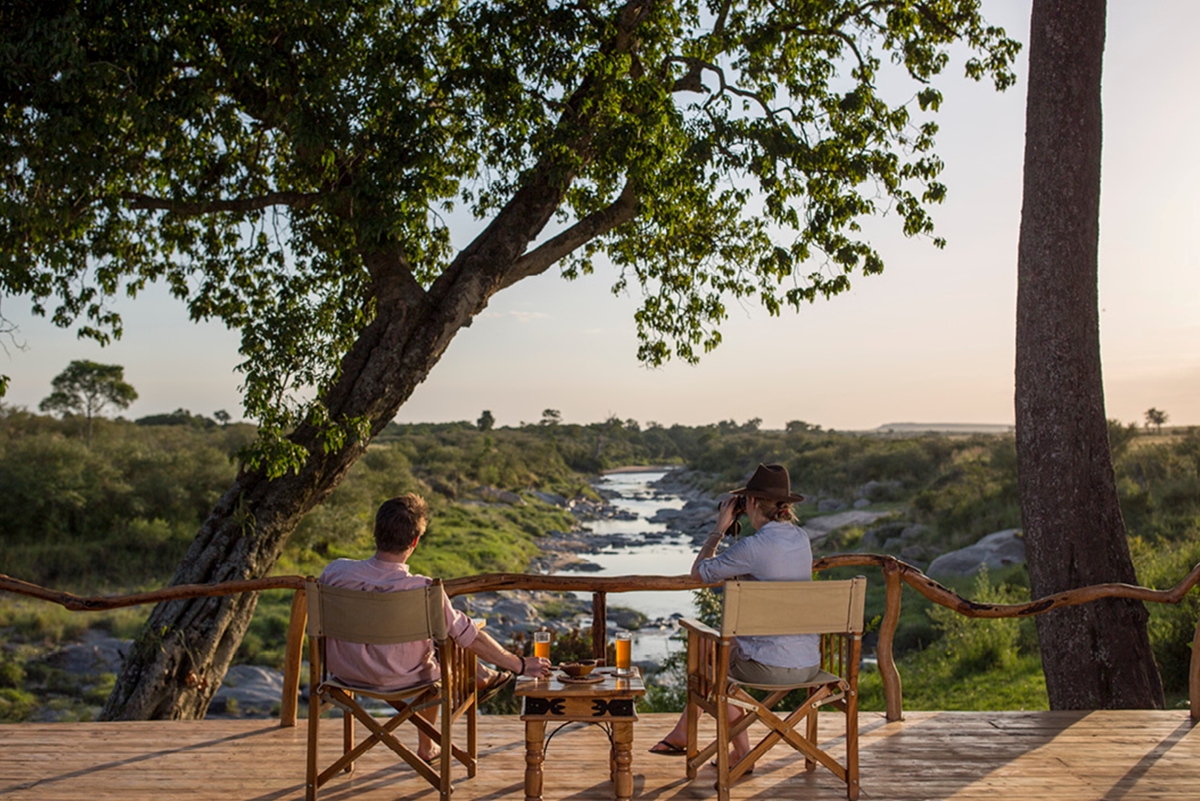 Couple enjoying the river views from an elevated wooden deck