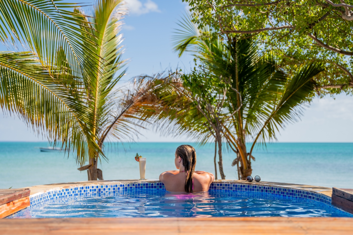 Woman relaxing in her ocean-front plunge pool