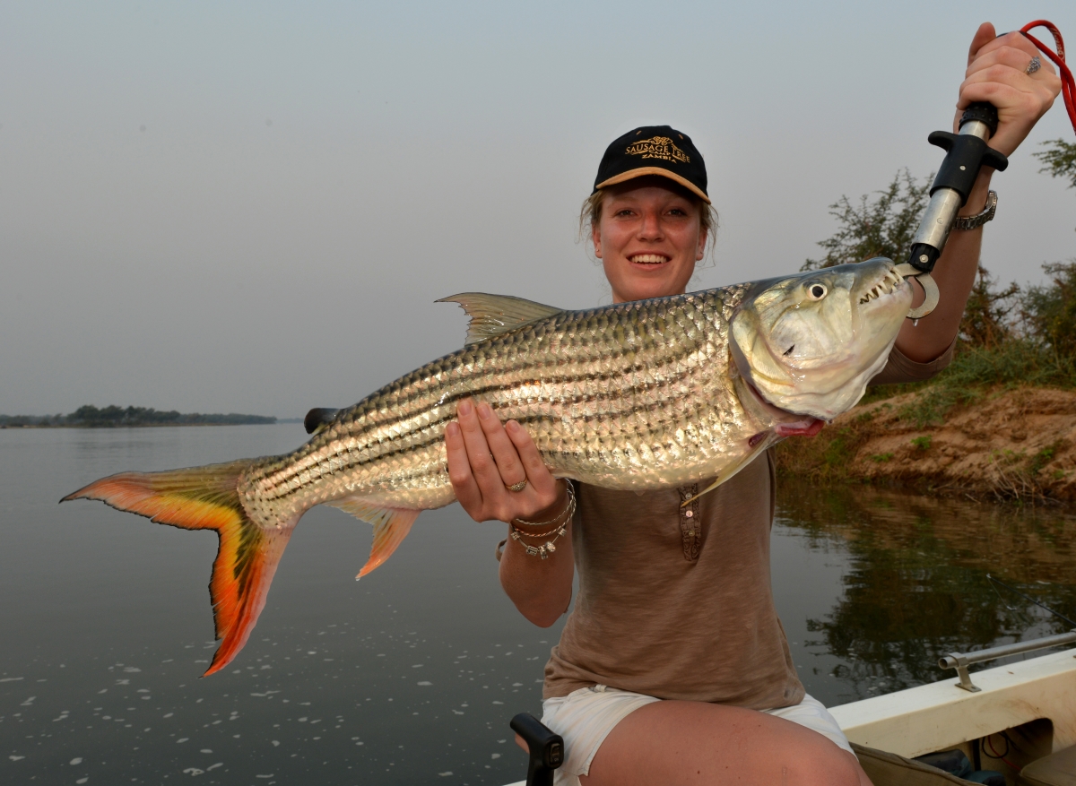 Woman posing with her Tiger Fish catch