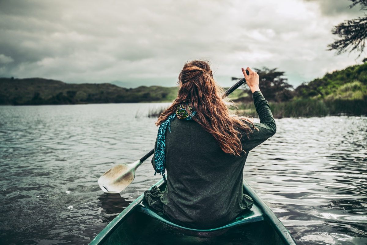 Woman paddling in a canoe