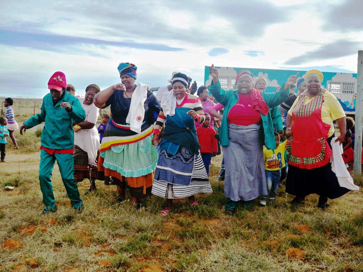 Community members dancing in traditional garb