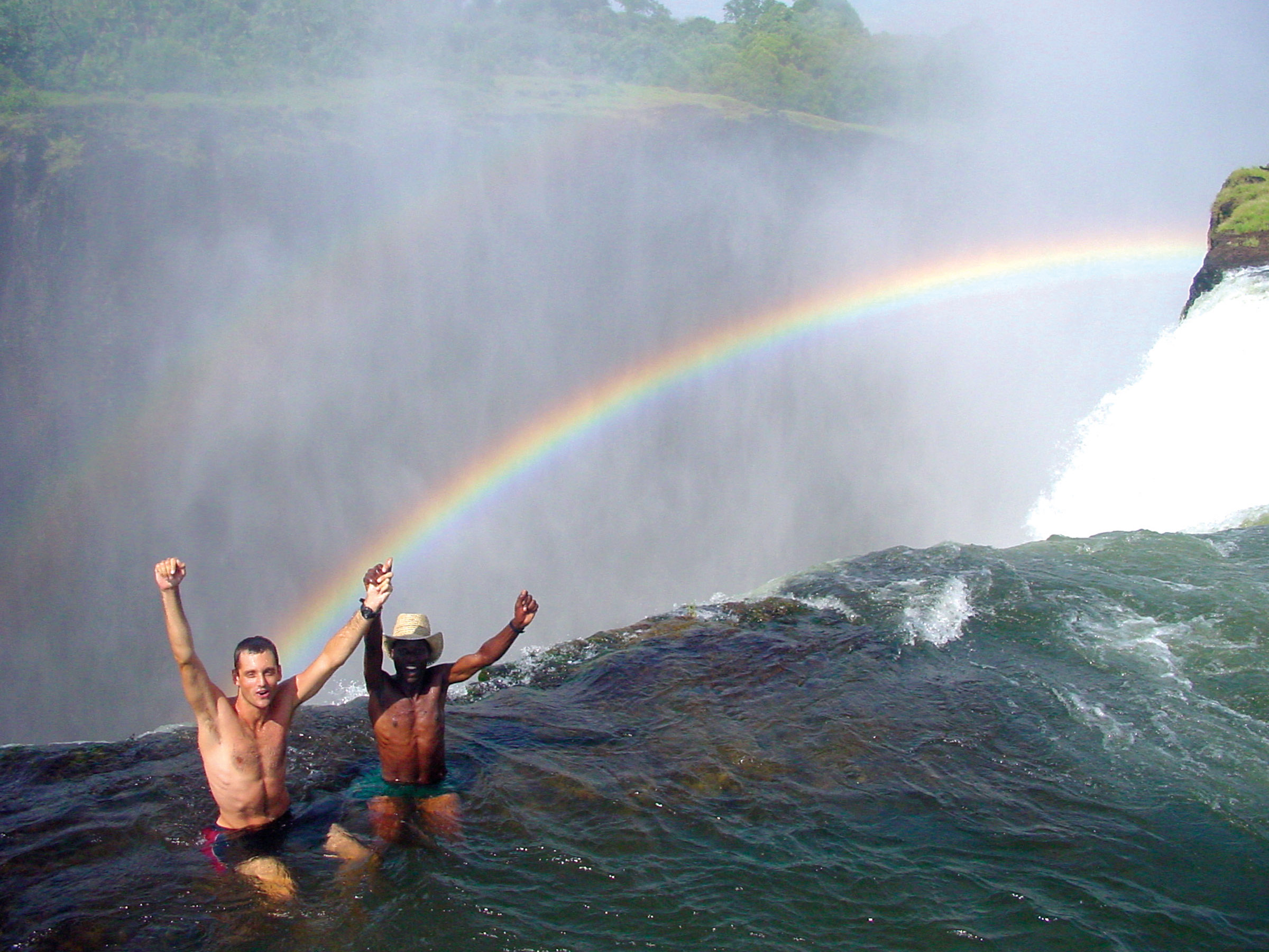 Two men swimming in Devil's Pool