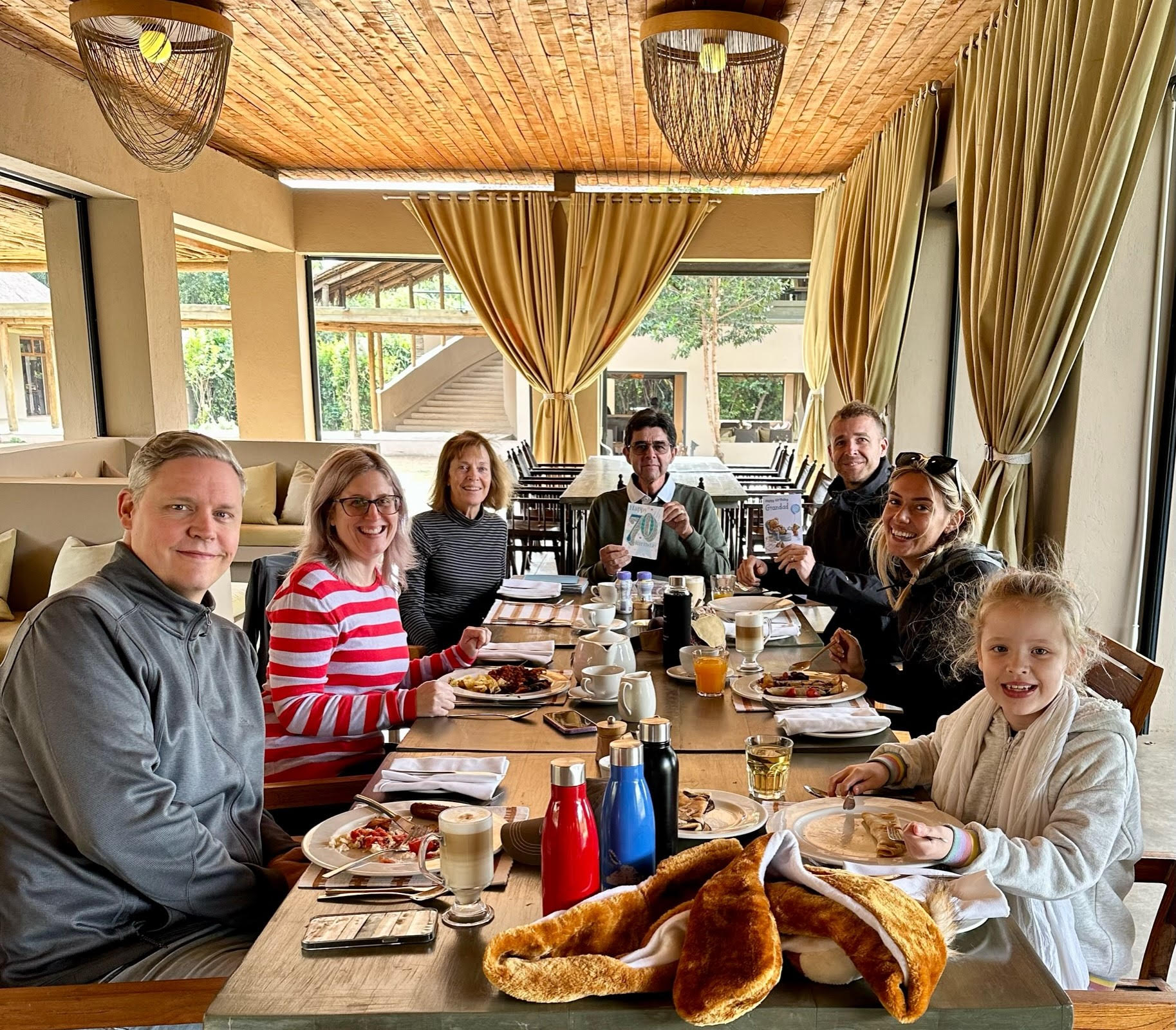 Eddie and family at a dinner table celebrating his 70th birthday