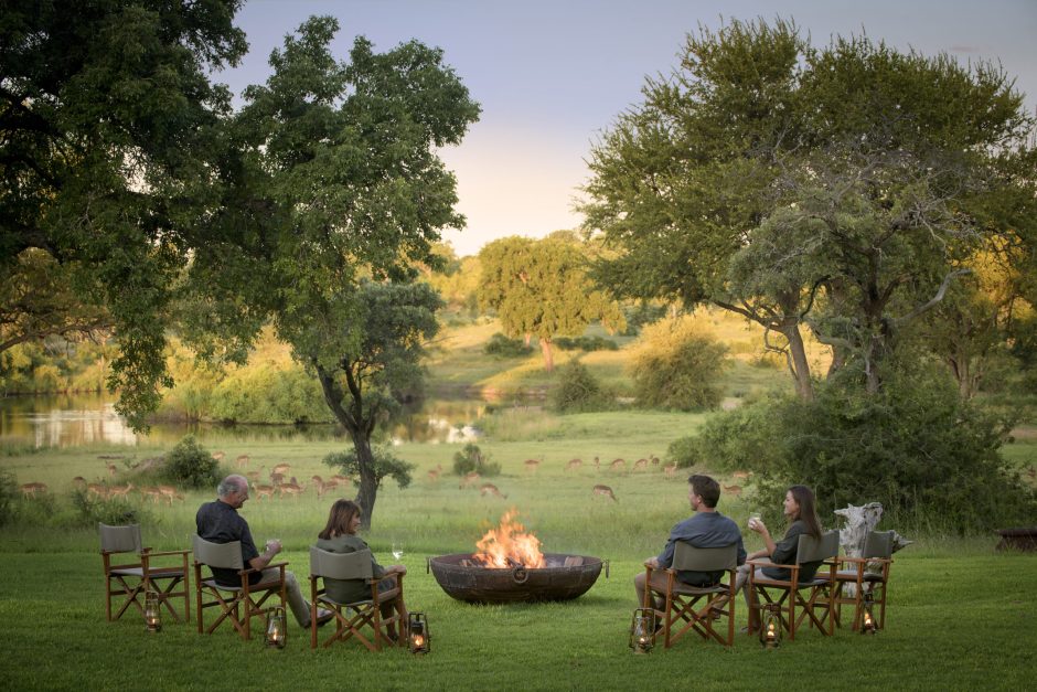 Drinks by the fire on safari at Singita Castleton with loved ones